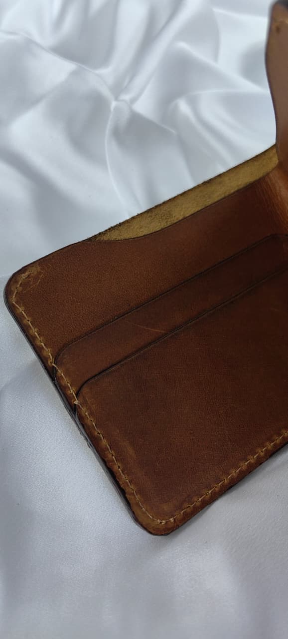 MNSA full-grain leather bifold wallet, real product photography, angle 1