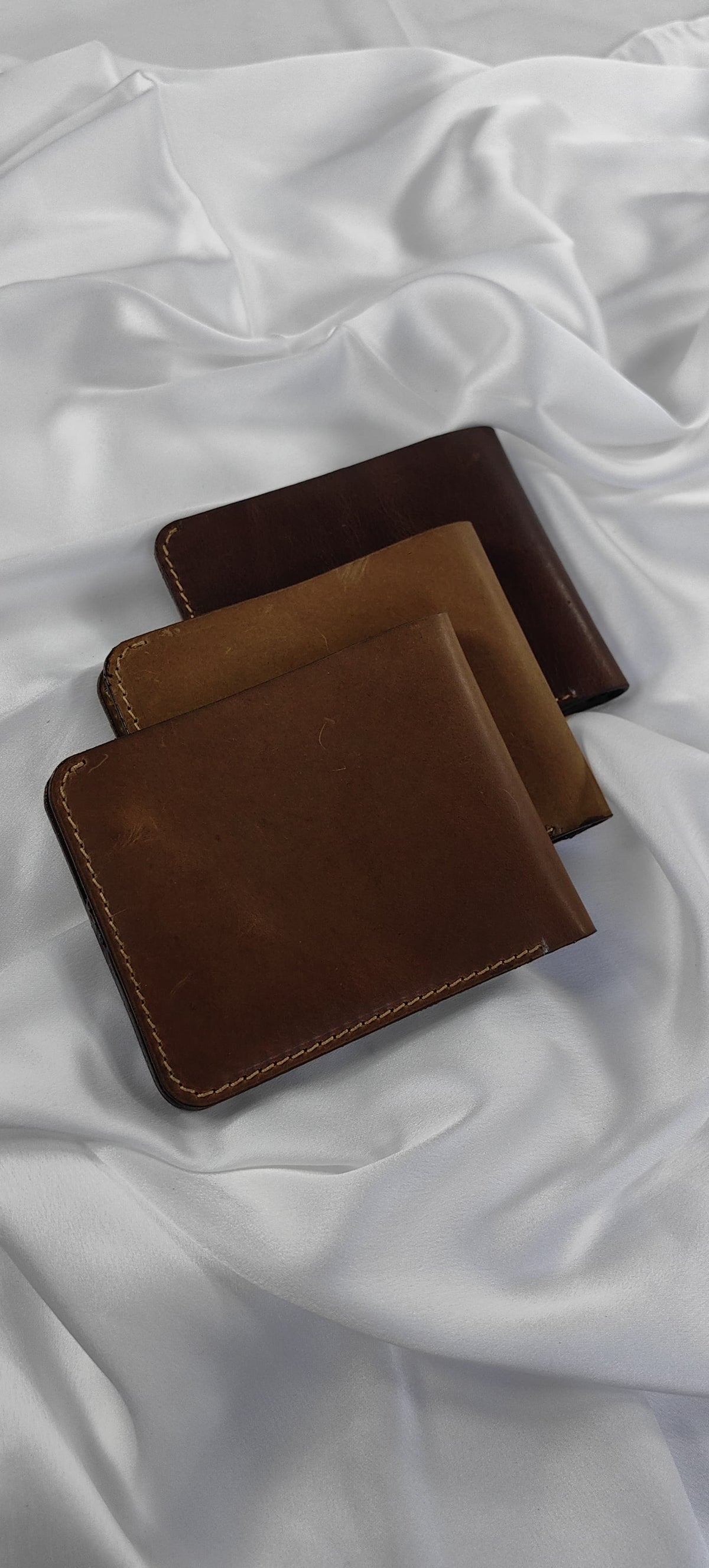MNSA full-grain leather bifold wallet, real product photography, angle 3