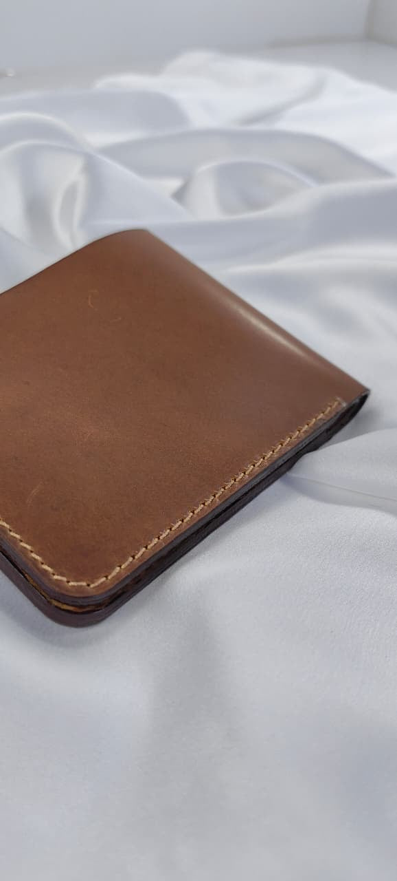 MNSA full-grain leather bifold wallet, real product photography, angle 2