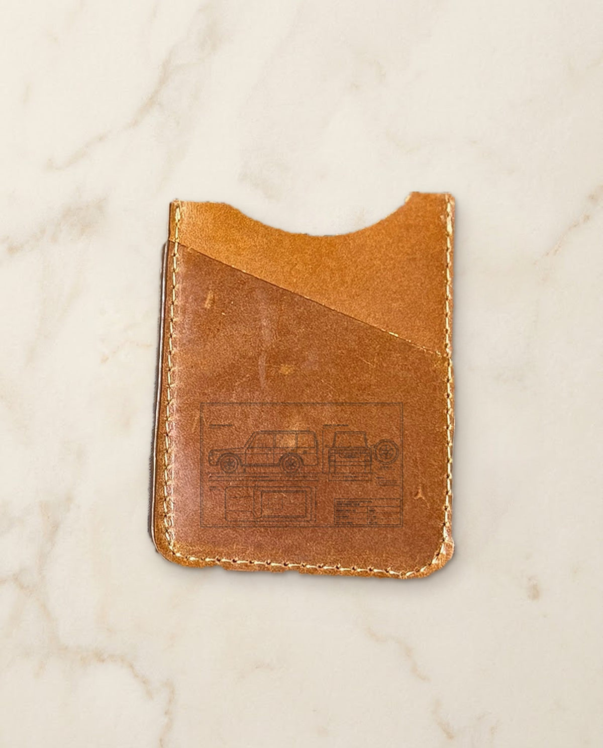 Car blueprint engraved on a cognac leather card holder