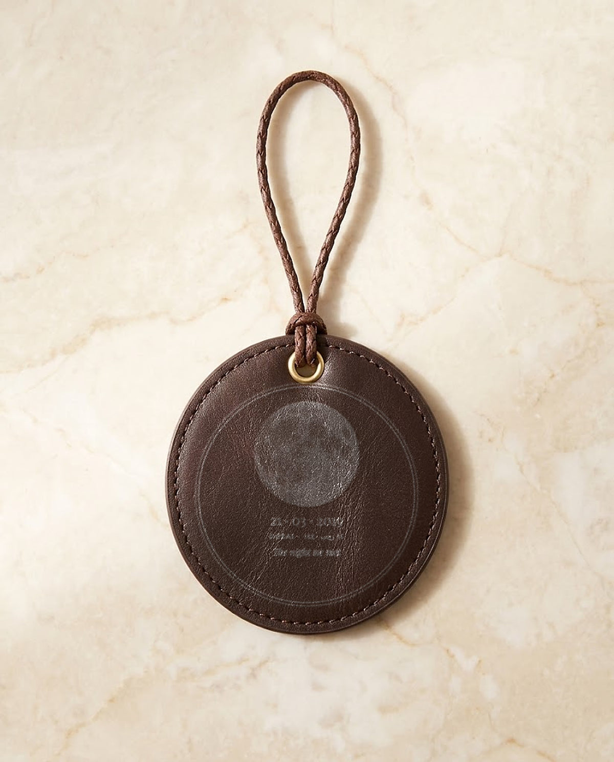 Moon and date engraved on a leather hanging medal