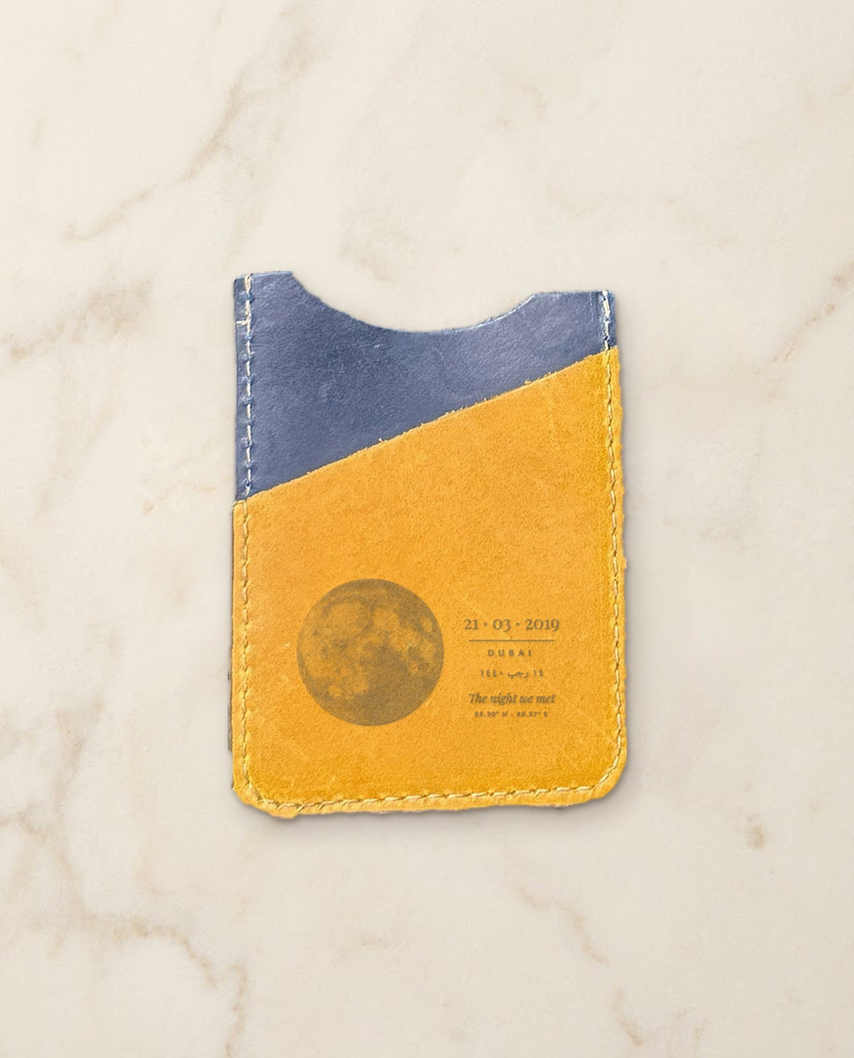 Moon and date engraved on a navy and honey leather card holder
