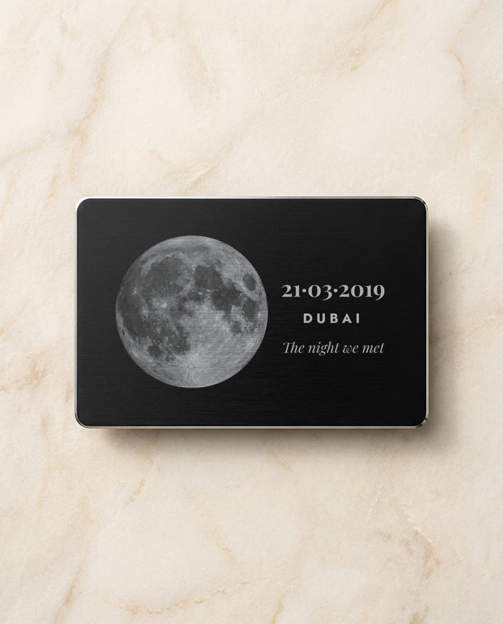 Moon and date engraved in bright steel on a black metal card