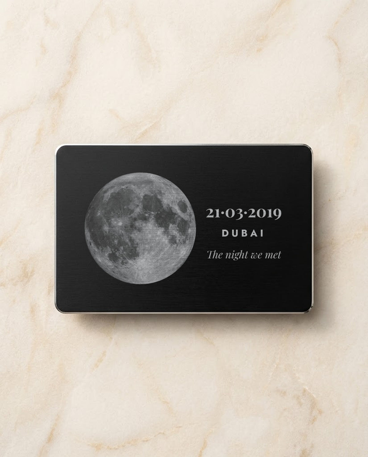Moon and date engraved in bright steel on a black metal card
