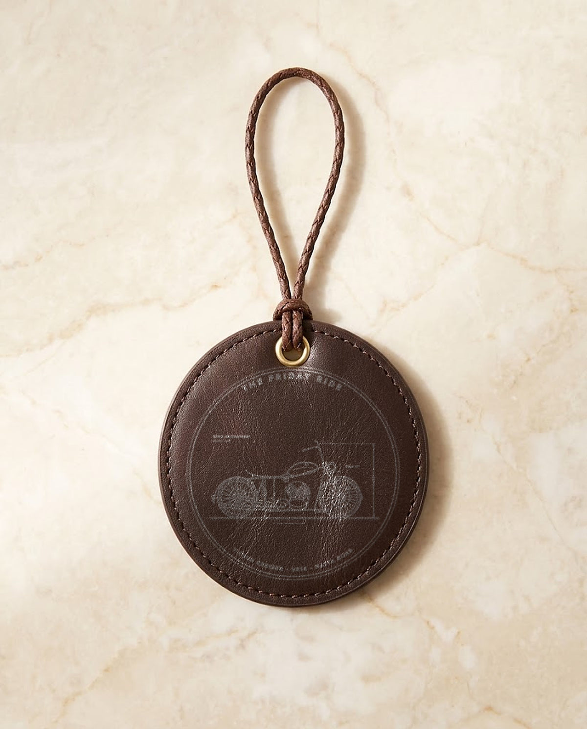 Motorbike blueprint engraved on a leather hanging medal