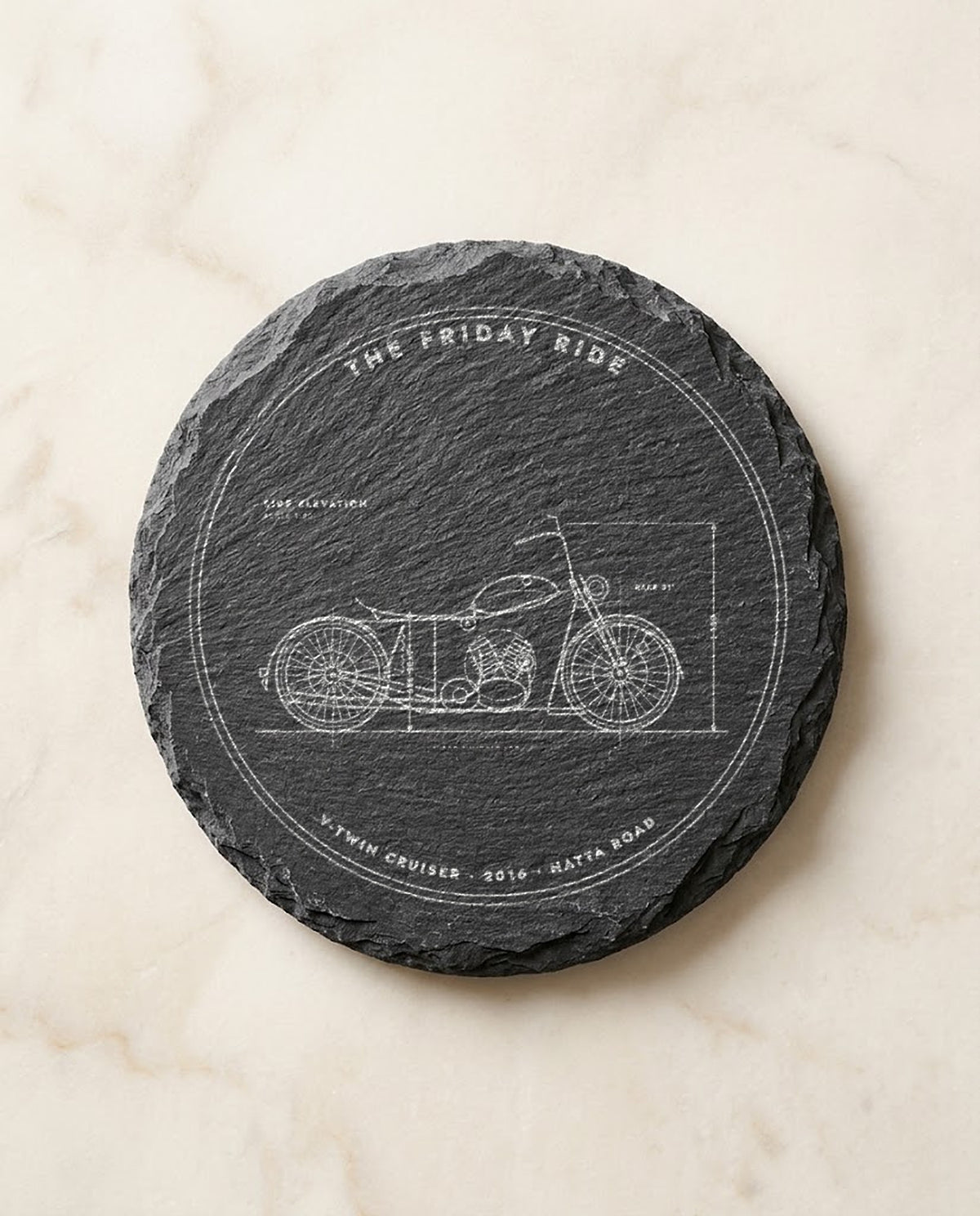 Motorbike blueprint engraved on a round slate coaster