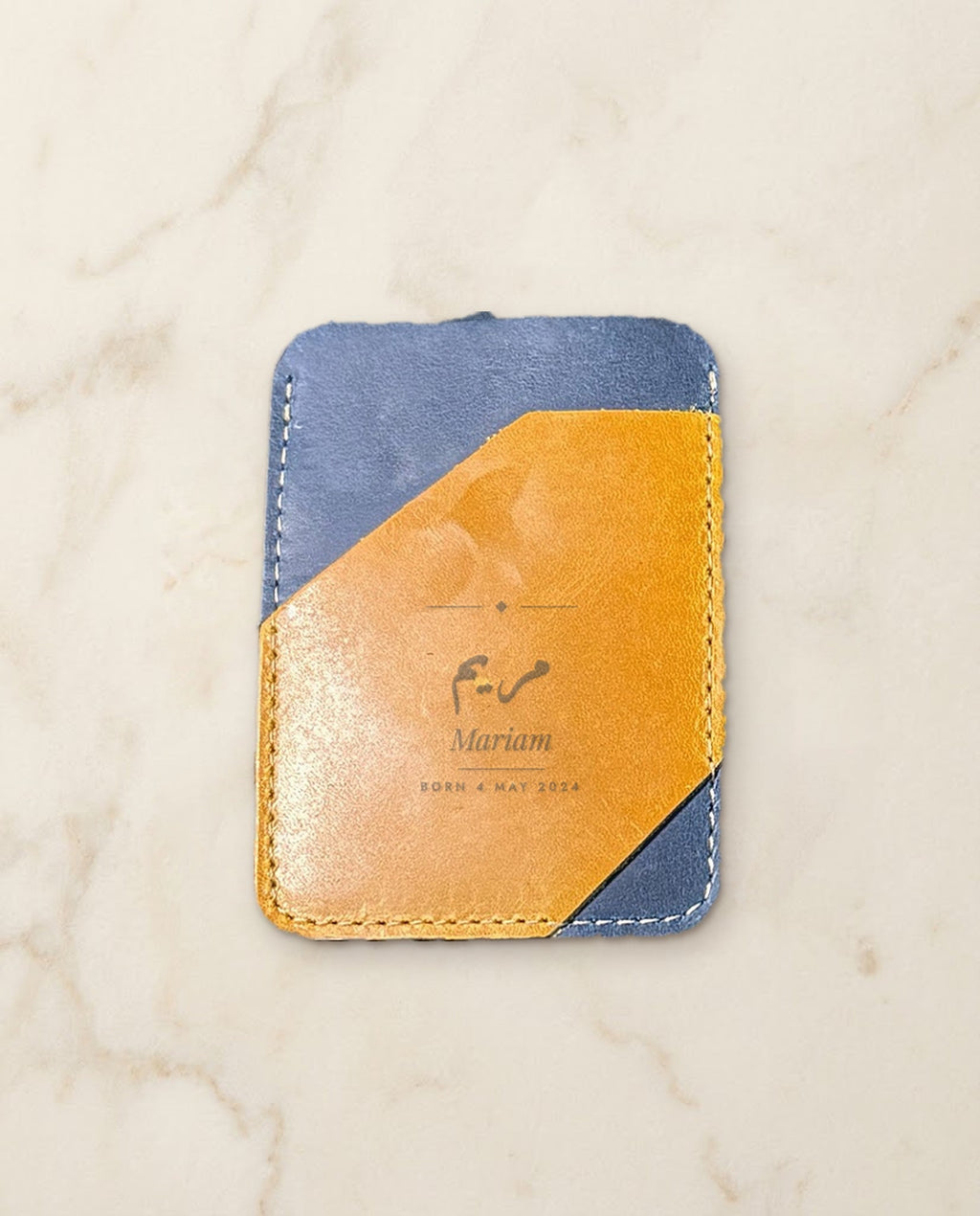 Arabic and English name engraved on a navy and honey leather card holder