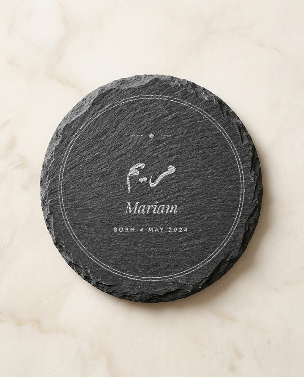 Arabic and English name engraved on a round slate coaster