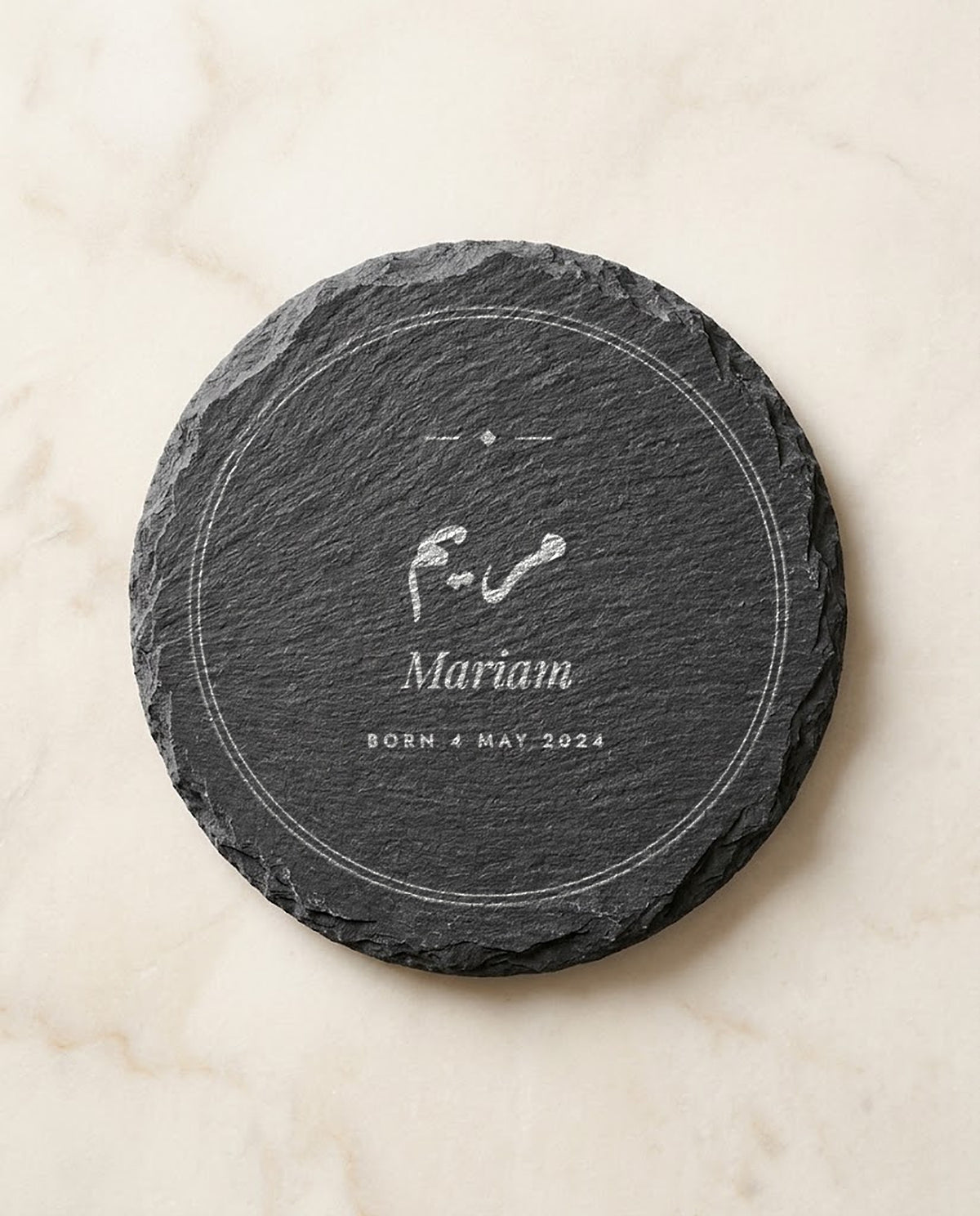 Arabic and English name engraved on a round slate coaster