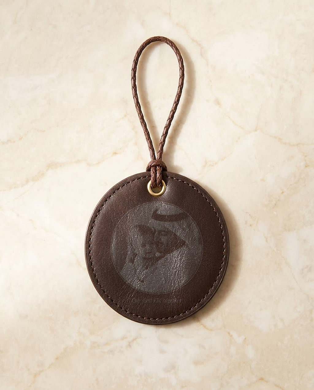 Family photo engraved on a leather hanging medal