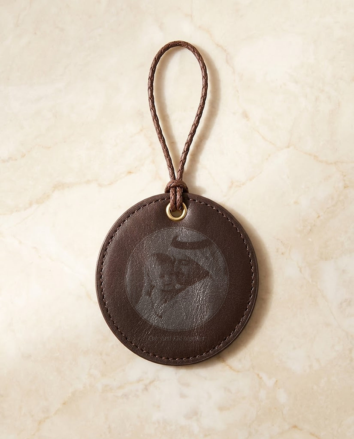 Family photo engraved on a leather hanging medal