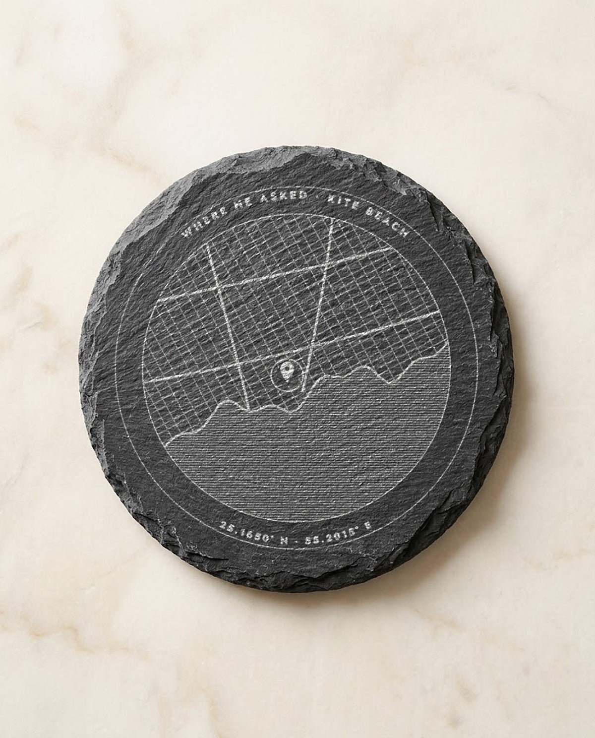 Street map with pin and coordinates engraved on a round slate coaster